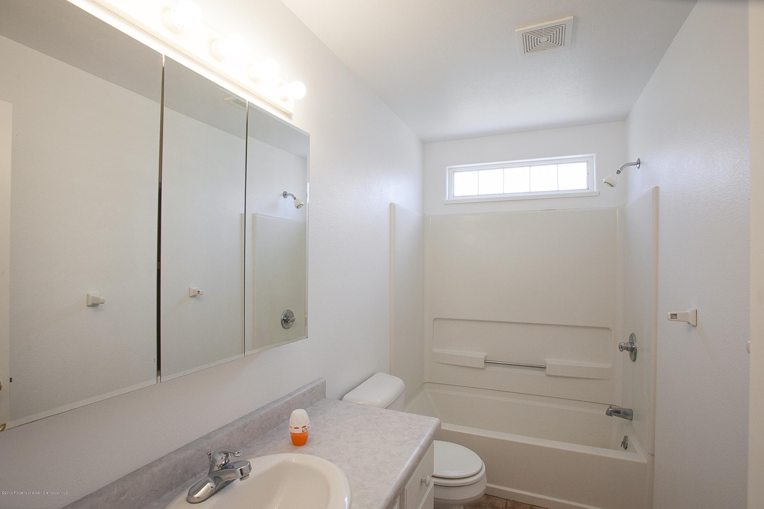 413 Evergreen Drive Rifle, CO 81650 - Photo 8 of 19 a bathroom with a sink a toilet and shower
