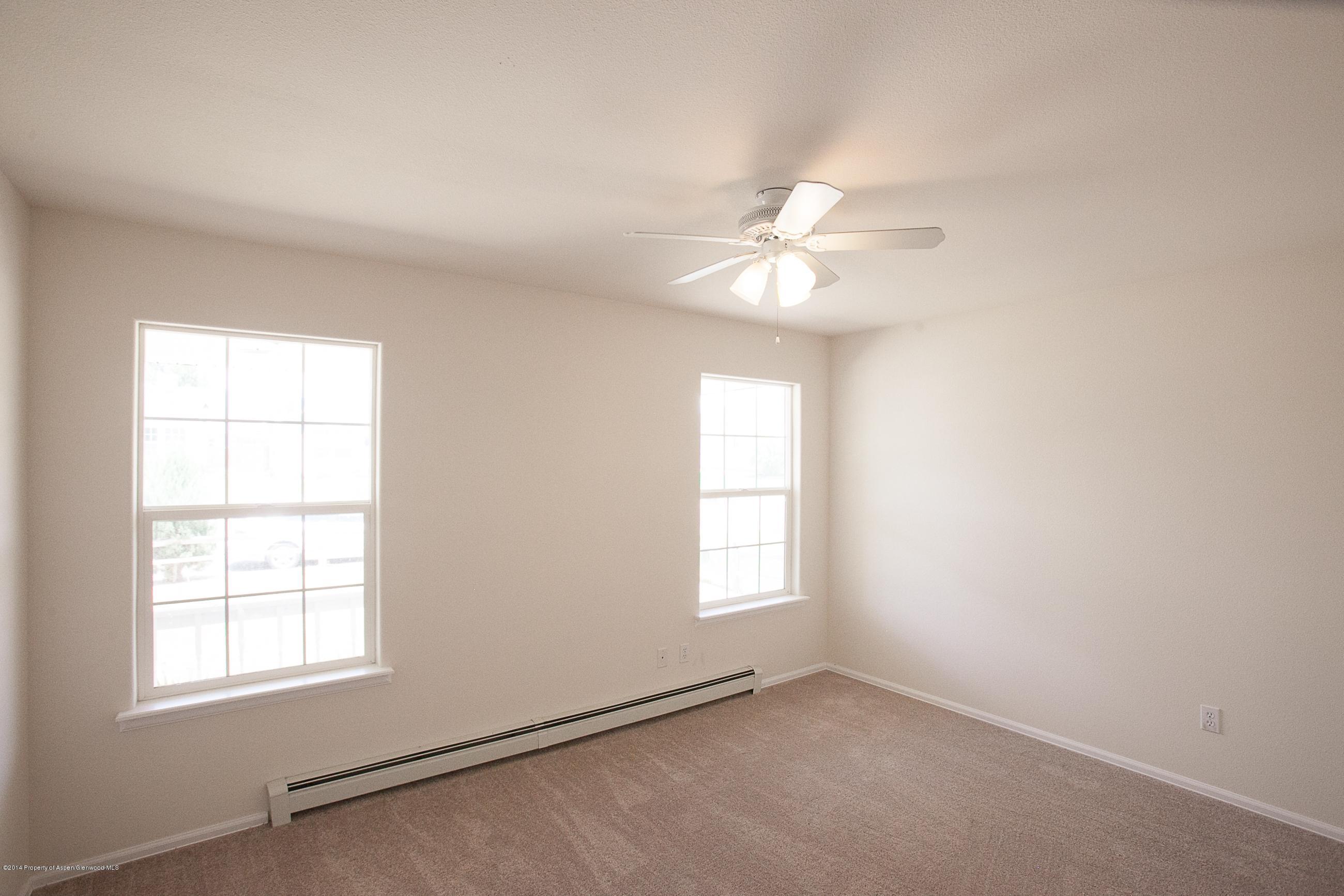 413 Evergreen Drive Rifle, CO 81650 - Photo 9 of 19 an empty room with windows and fan