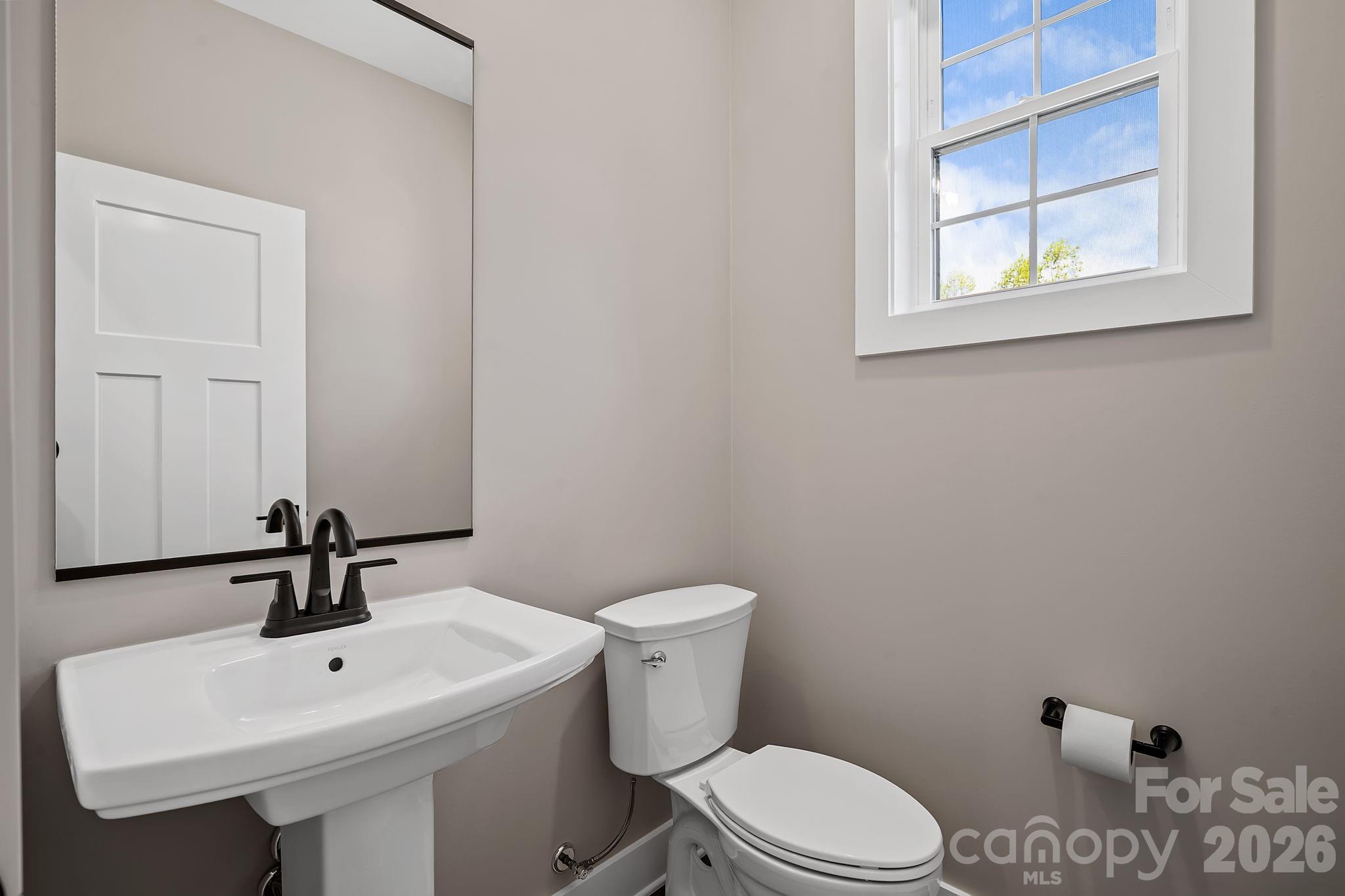 343 Olivette Road Asheville, NC 28804 - Photo 12 of 29 a bathroom with a sink a toilet and mirror