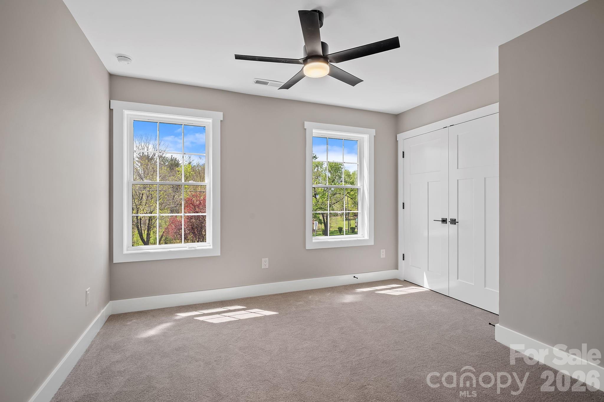 343 Olivette Road Asheville, NC 28804 - Photo 15 of 29 a view of a livingroom with a window and a ceiling fan