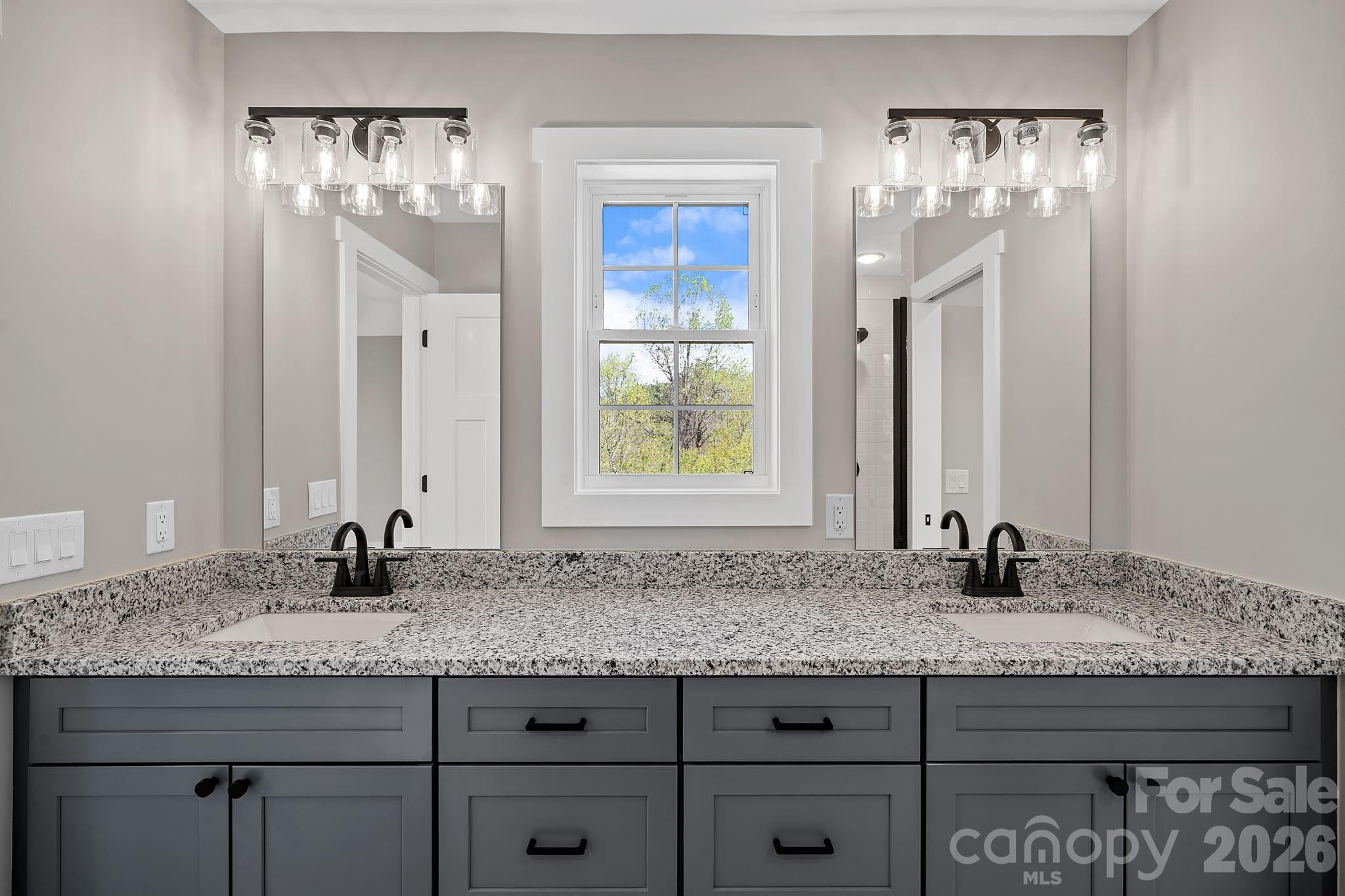 343 Olivette Road Asheville, NC 28804 - Photo 17 of 29 a bathroom with a granite countertop sink and a mirror