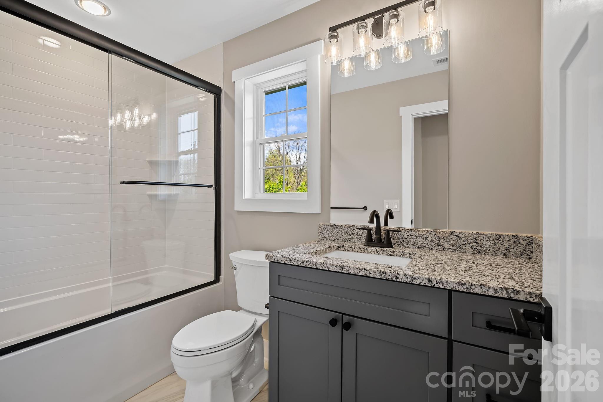343 Olivette Road Asheville, NC 28804 - Photo 22 of 29 a bathroom with a granite countertop sink toilet and shower