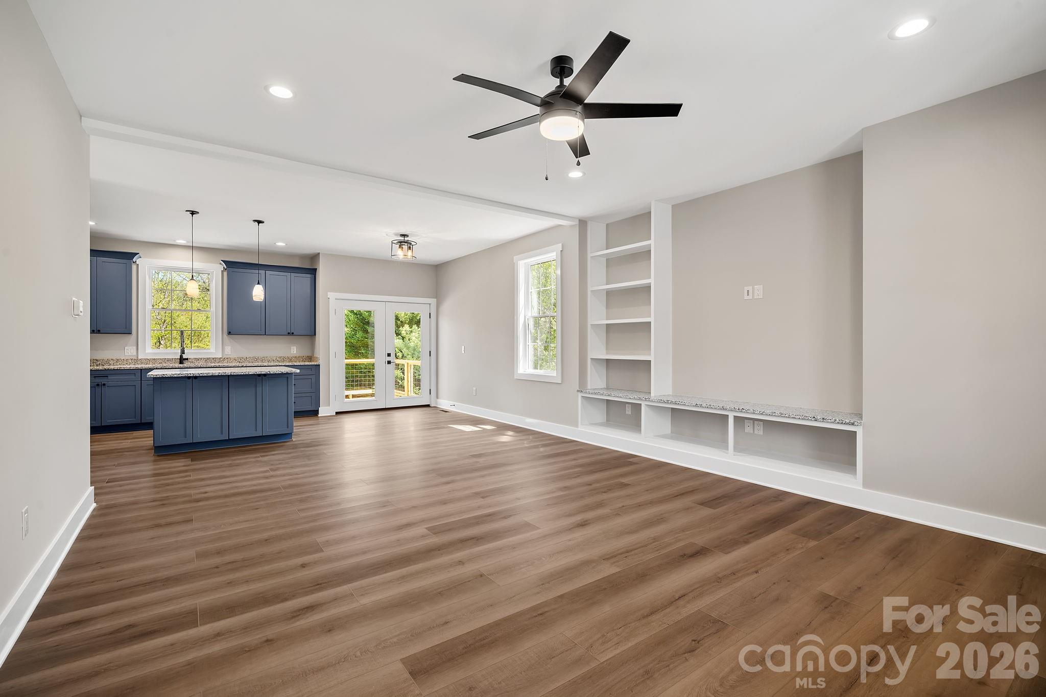 343 Olivette Road Asheville, NC 28804 - Photo 3 of 29 a view of an empty room with a window and wooden floor