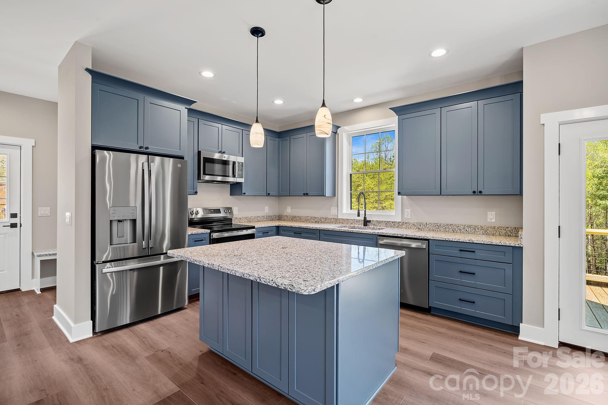 343 Olivette Road Asheville, NC 28804 - Photo 6 of 29 a kitchen with stainless steel appliances granite countertop a sink a stove a refrigerator and a center island
