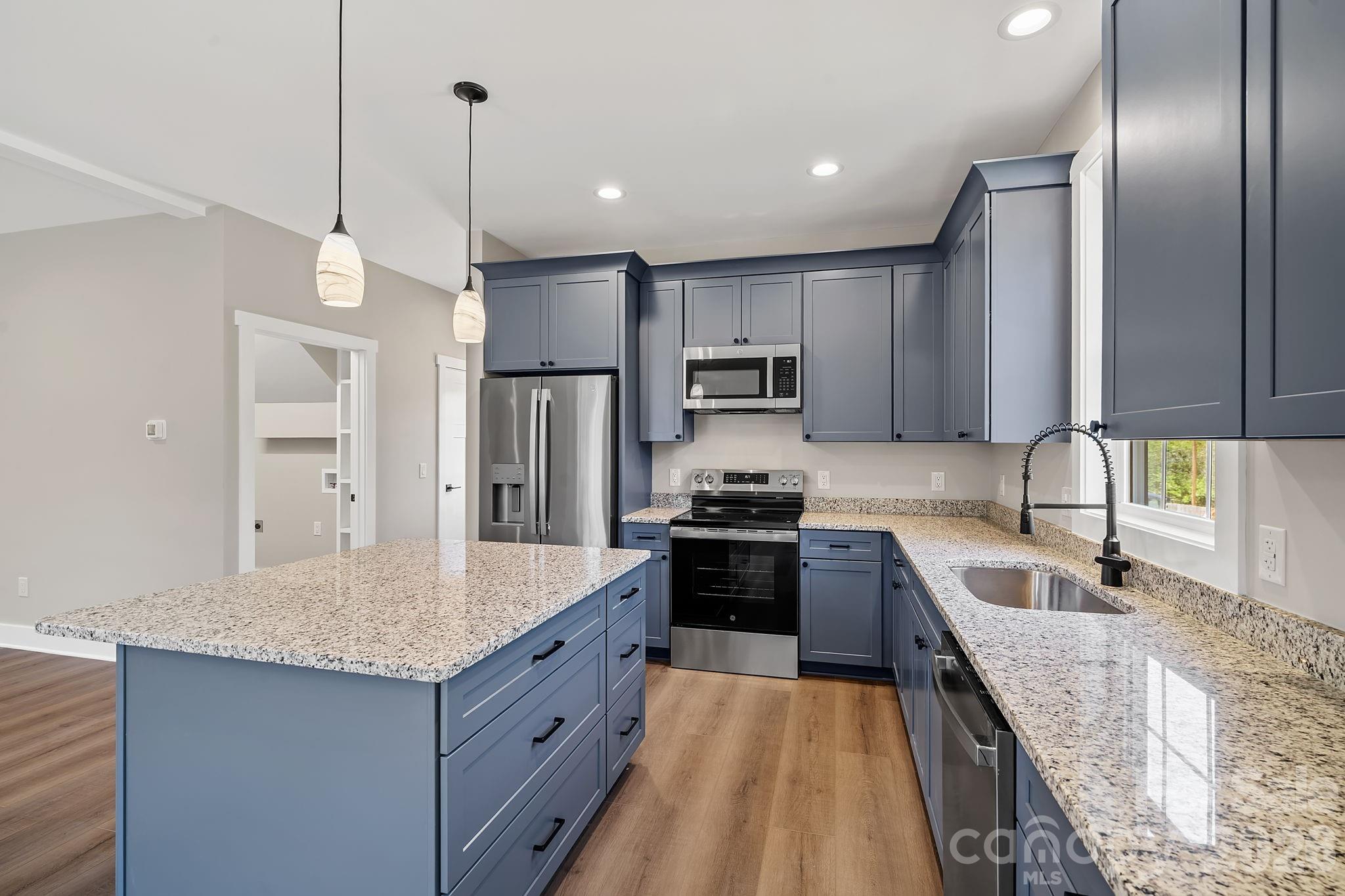 343 Olivette Road Asheville, NC 28804 - Photo 7 of 29 a kitchen with stainless steel appliances granite countertop a sink stove and refrigerator
