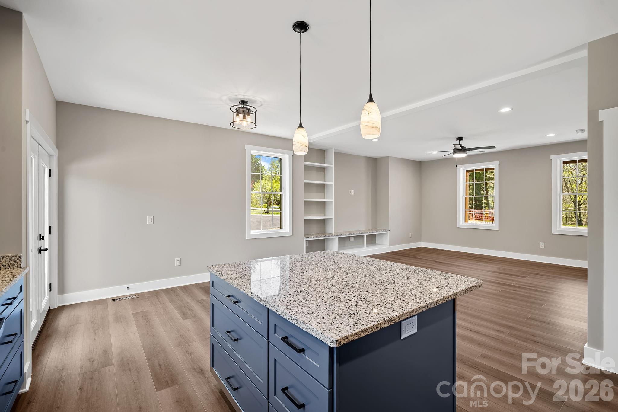 343 Olivette Road Asheville, NC 28804 - Photo 9 of 29 a kitchen with a sink granite countertop cabinets and wooden floor
