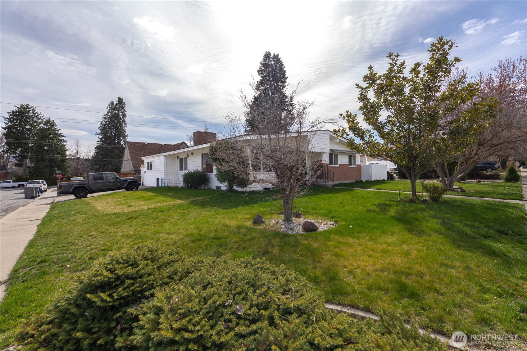 33 North Furney Street Wenatchee, WA 98801 - Photo 21 of 30 a view of a house with a big yard and large trees