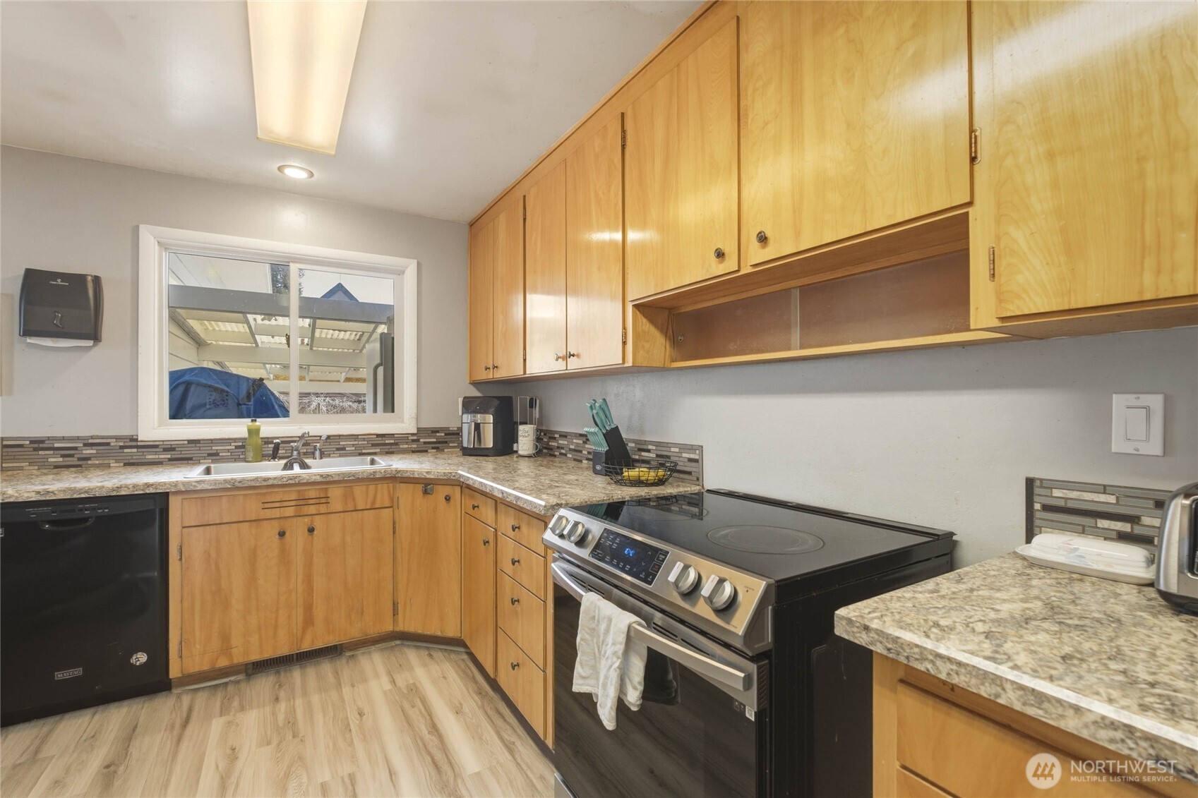33 North Furney Street Wenatchee, WA 98801 - Photo 8 of 30 a kitchen with a stove a sink and a cabinets