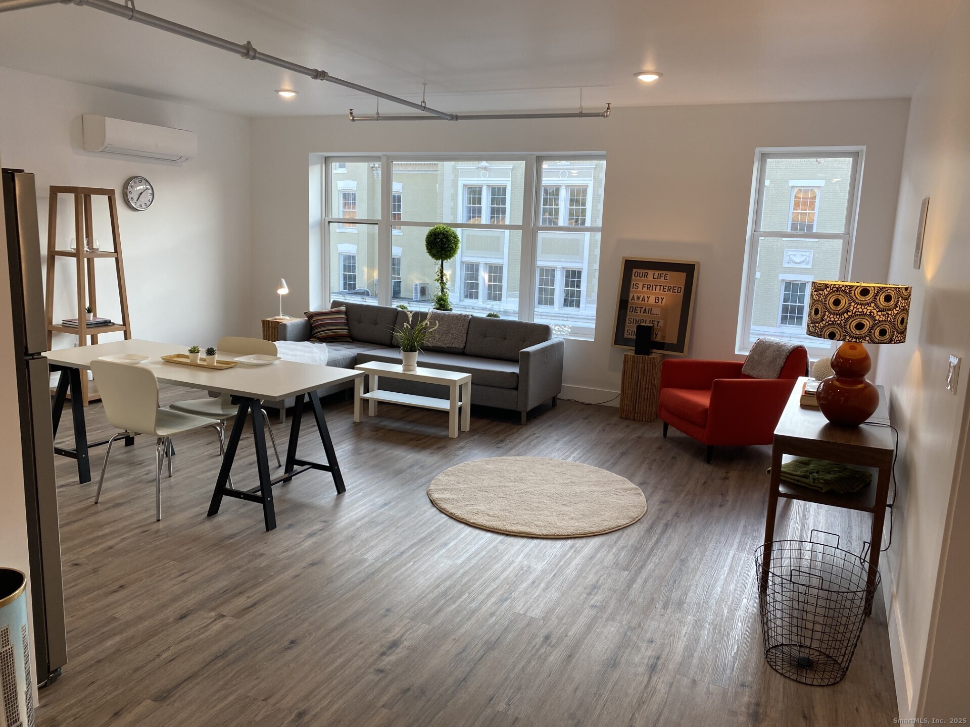 a living room with furniture and a wooden floor