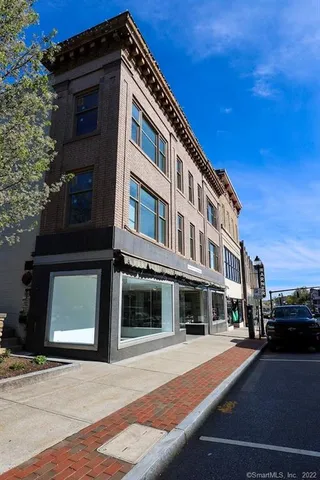 a front view of a building with parking space