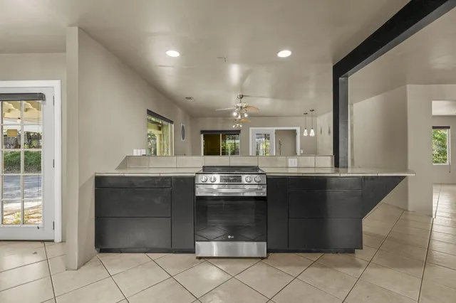 a view of a house with backyard and sitting area