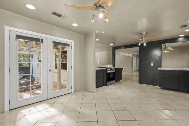 a view of a patio with a table and chairs under an umbrella