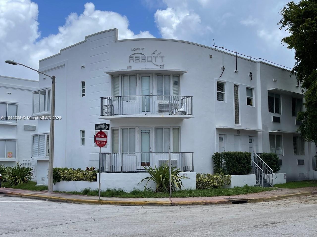 320 80th Street, Unit 6 Miami Beach, FL 33141 - Photo 1 of 33 a front view of a building with potted plants
