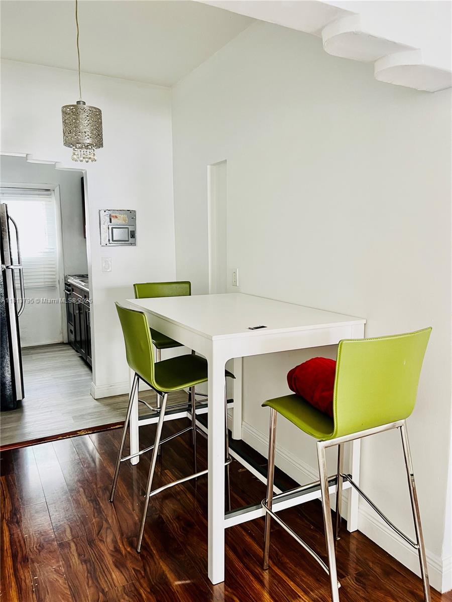 320 80th Street, Unit 6 Miami Beach, FL 33141 - Photo 11 of 33 a view of a dining room with furniture and wooden floor