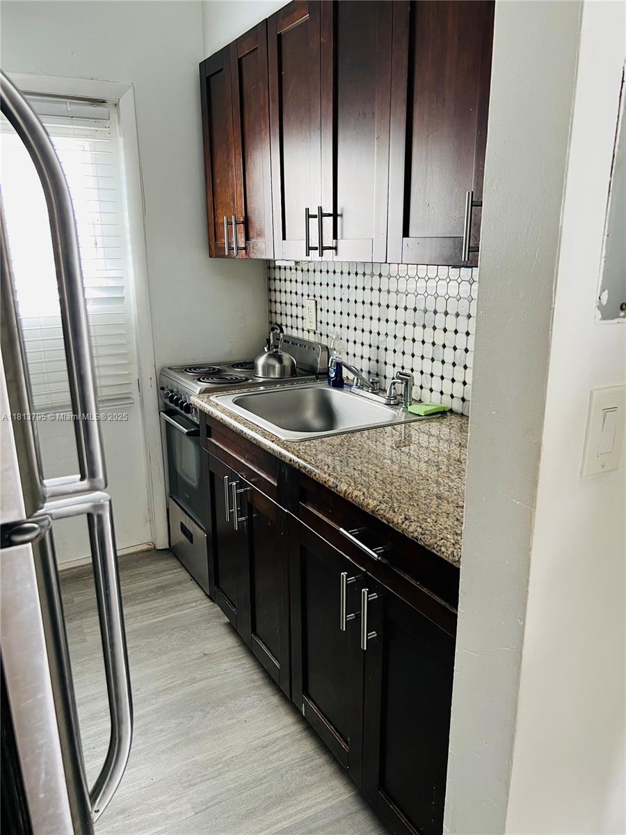 320 80th Street, Unit 6 Miami Beach, FL 33141 - Photo 15 of 33 a kitchen with sink and a refrigerator