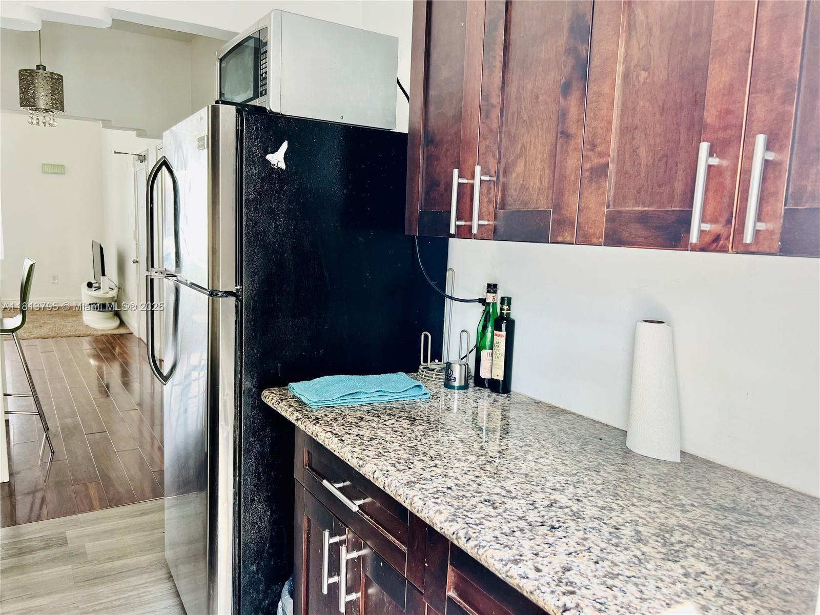 320 80th Street, Unit 6 Miami Beach, FL 33141 - Photo 18 of 33 a kitchen with a refrigerator and countertop