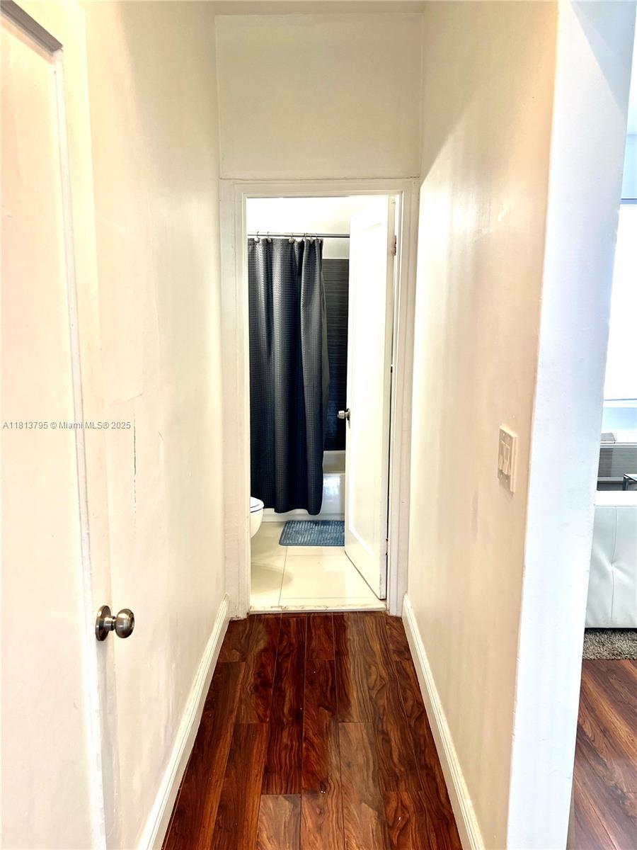 320 80th Street, Unit 6 Miami Beach, FL 33141 - Photo 19 of 33 a view of a hallway with wooden floor and staircase