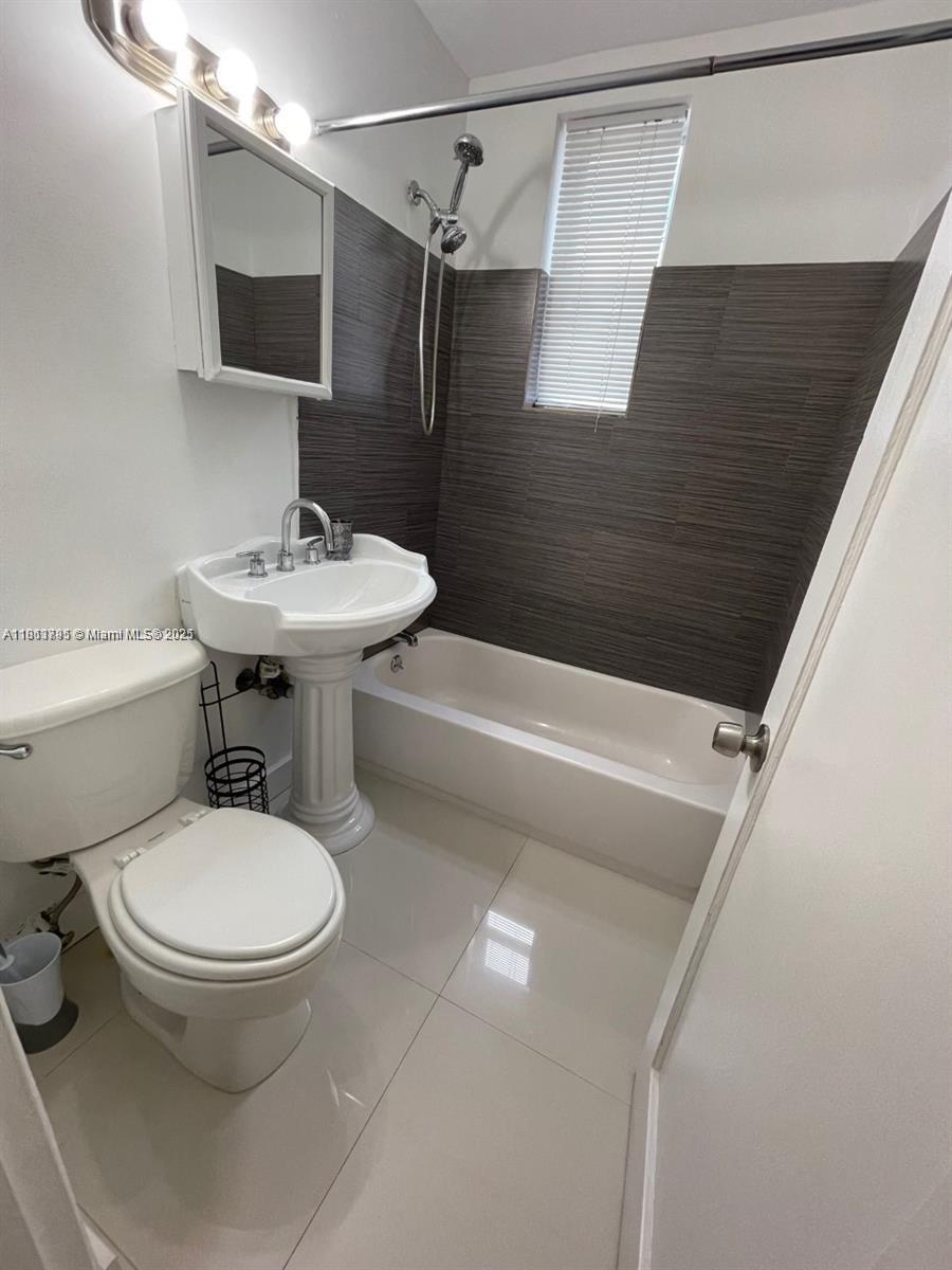 320 80th Street, Unit 6 Miami Beach, FL 33141 - Photo 20 of 33 a bathroom with a sink toilet and shower