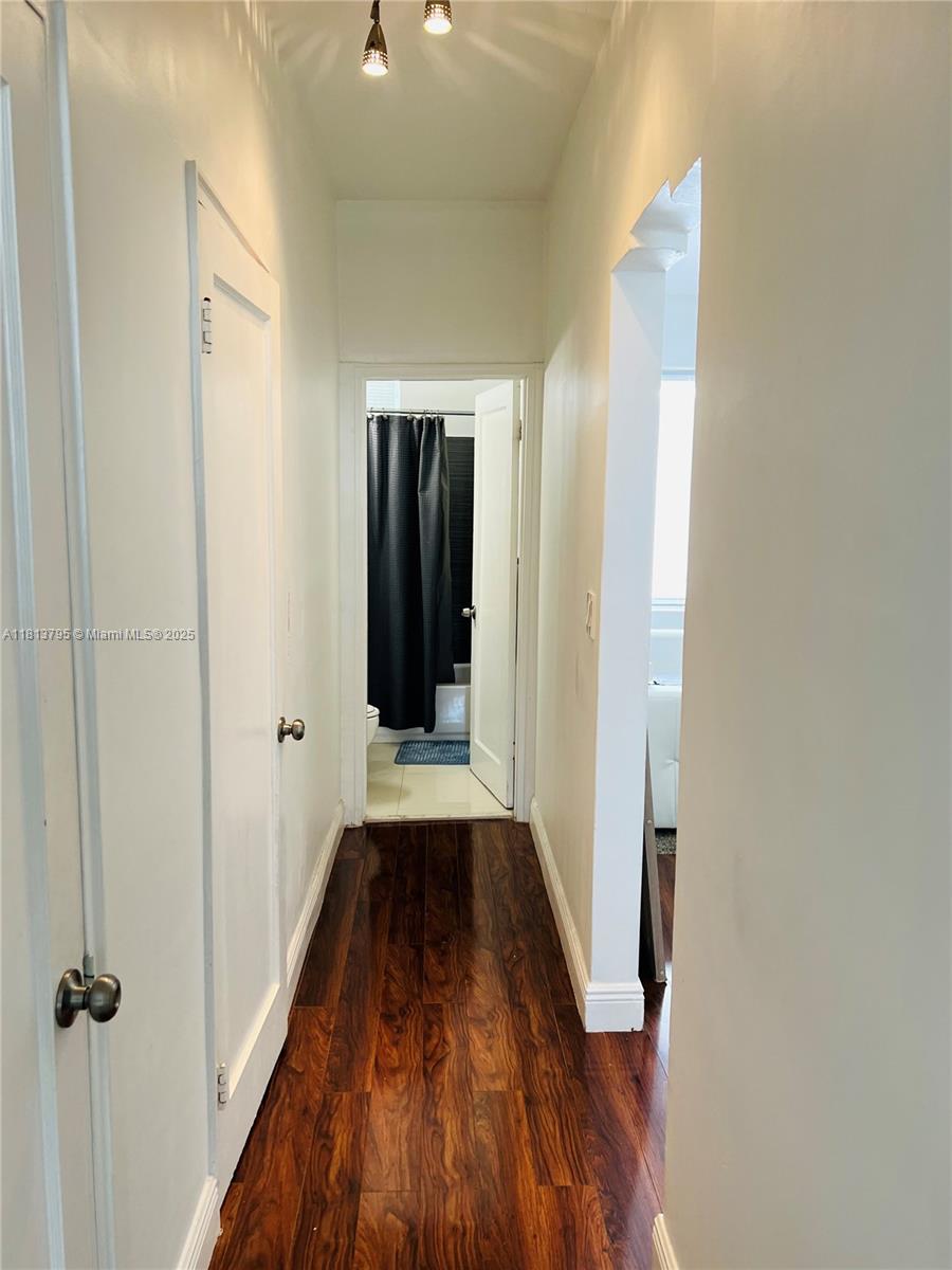 320 80th Street, Unit 6 Miami Beach, FL 33141 - Photo 24 of 33 a view of a hallway with wooden floor and staircase