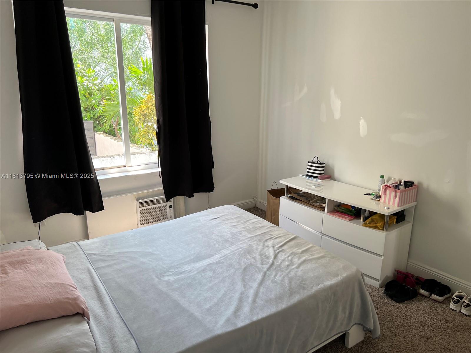 320 80th Street, Unit 6 Miami Beach, FL 33141 - Photo 28 of 33 a bedroom with a bed and a window