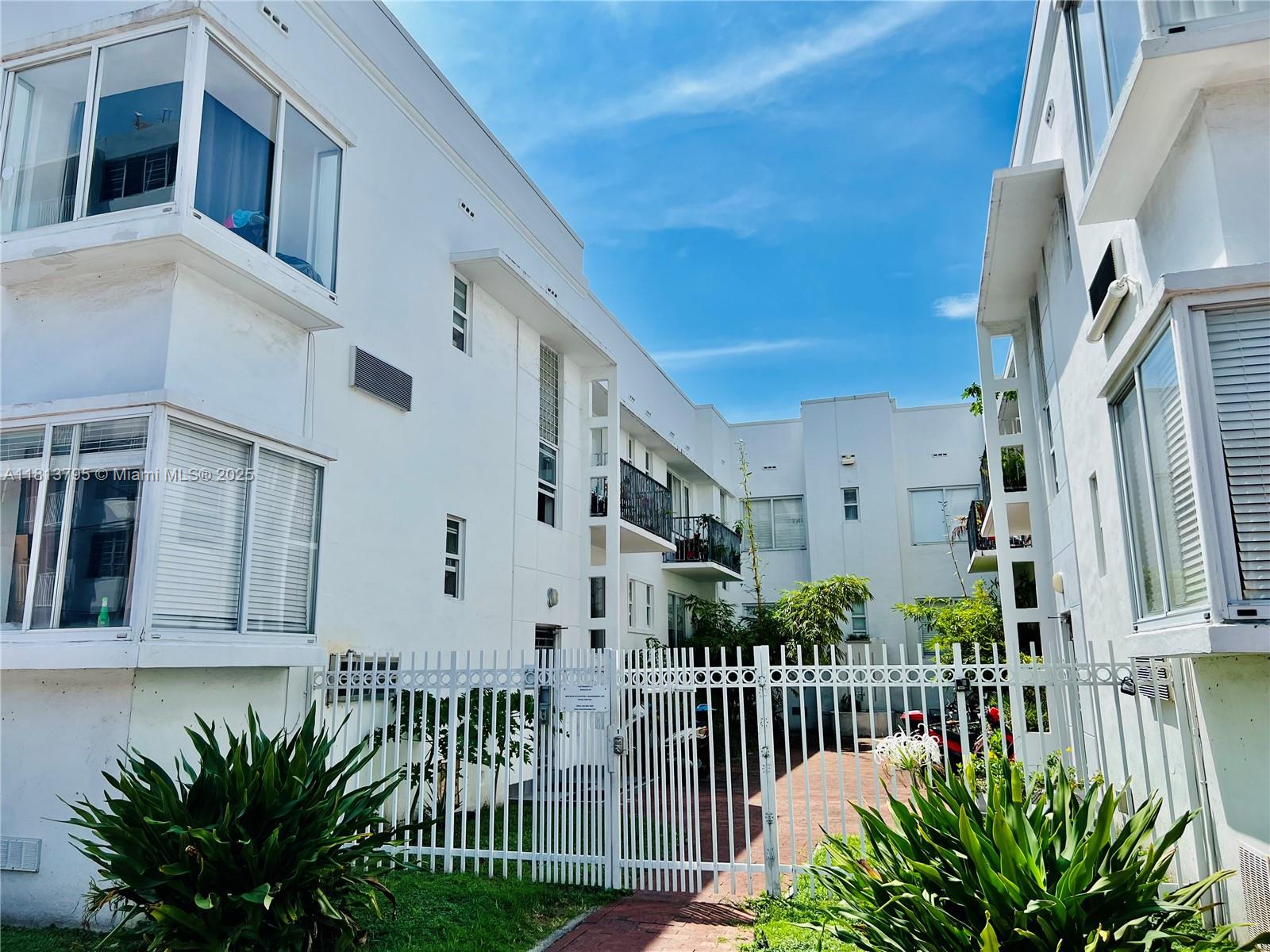 320 80th Street, Unit 6 Miami Beach, FL 33141 - Photo 33 of 33 a view of a house with a small yard