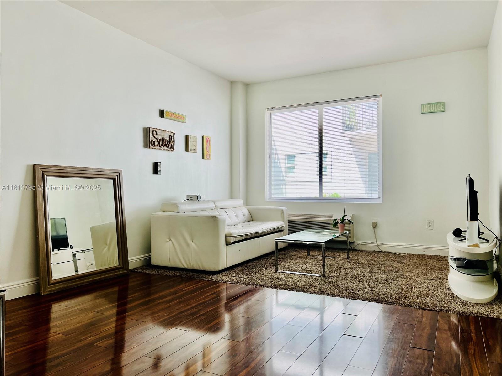 320 80th Street, Unit 6 Miami Beach, FL 33141 - Photo 4 of 33 a living room with furniture and a window