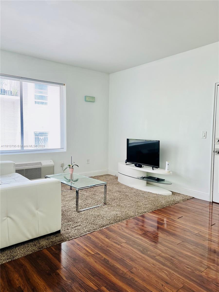 320 80th Street, Unit 6 Miami Beach, FL 33141 - Photo 5 of 33 a living room with furniture and a flat screen tv
