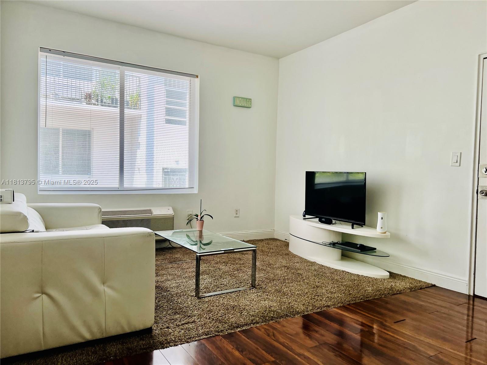320 80th Street, Unit 6 Miami Beach, FL 33141 - Photo 6 of 33 a living room with furniture and a flat screen tv