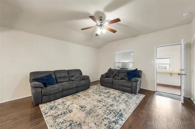a kitchen with kitchen island a dining table and chairs