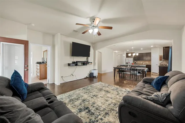 a living room with furniture and wooden floor