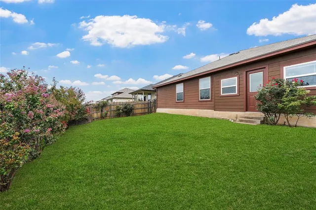 a backyard of a house with lots of green space