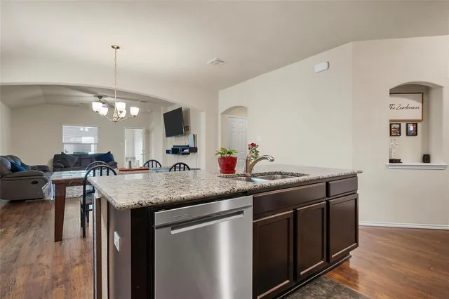 a kitchen with granite countertop stainless steel appliances and wooden cabinets