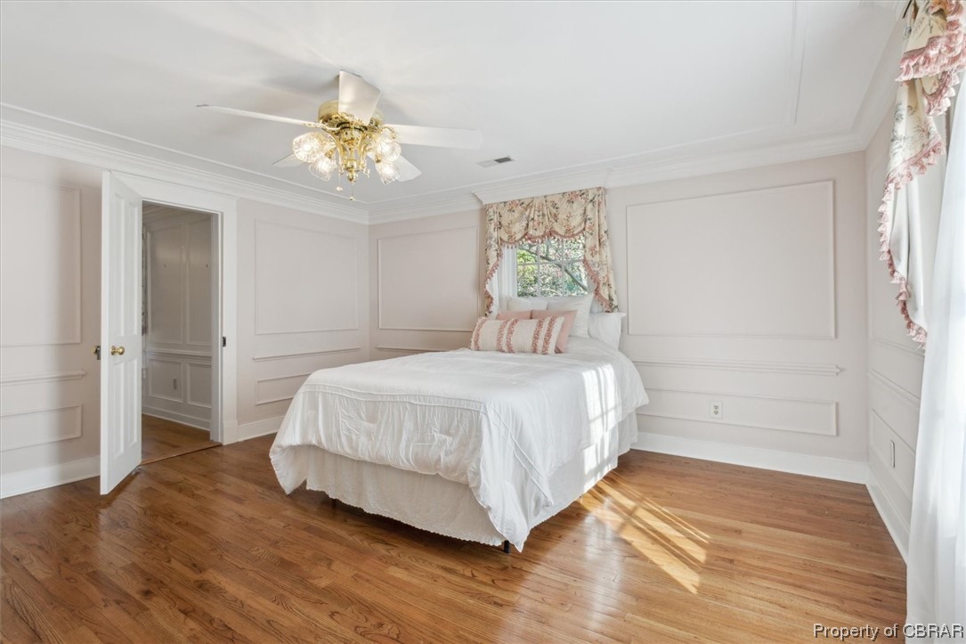 7175 Ware House Road Gloucester, VA 23061 - Photo 20 of 39 Hardwood floored bedroom featuring crown molding and ceiling fan