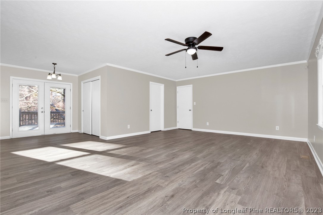 610 Arrowood Road Fayetteville, NC 28311 - Photo 11 of 26 a view of empty room with wooden floor and fan