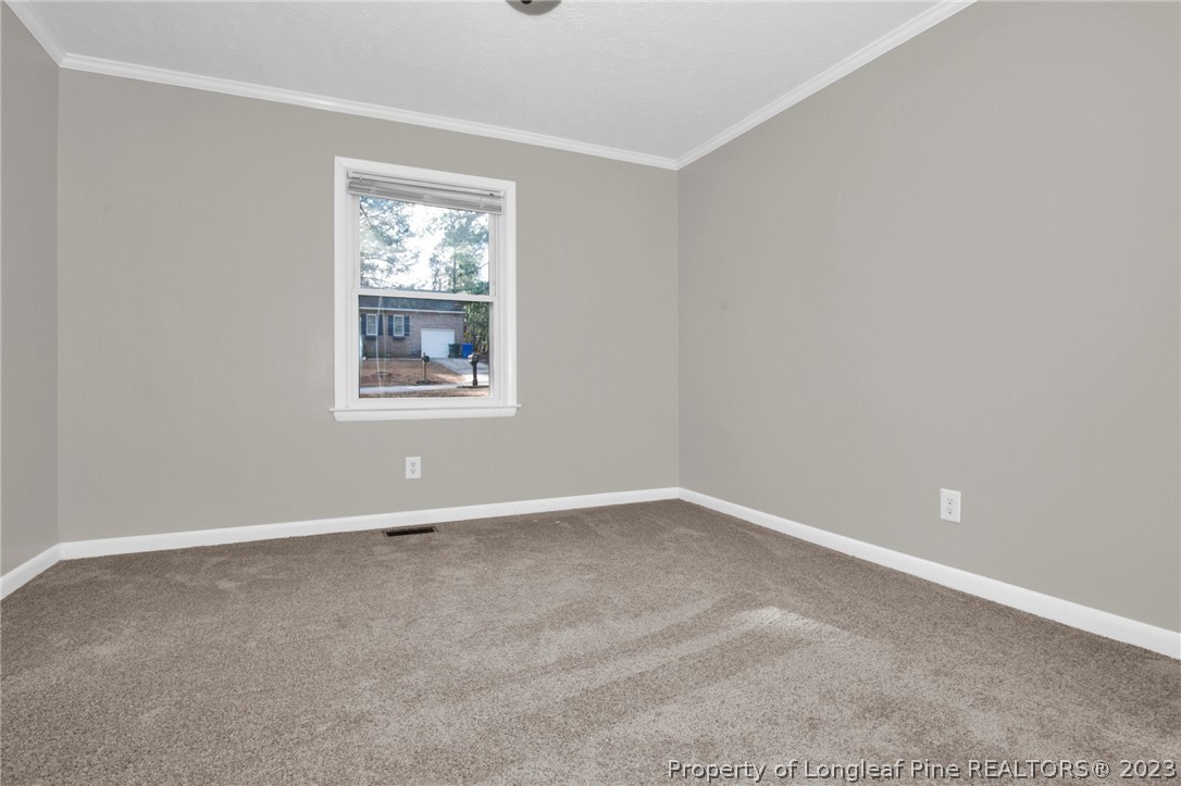 610 Arrowood Road Fayetteville, NC 28311 - Photo 14 of 26 an empty room with windows