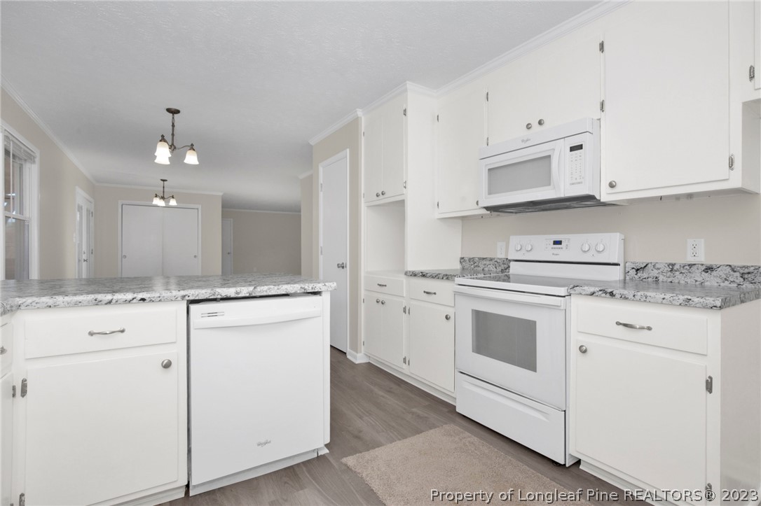 610 Arrowood Road Fayetteville, NC 28311 - Photo 16 of 26 a kitchen with cabinets appliances a sink and a counter top space