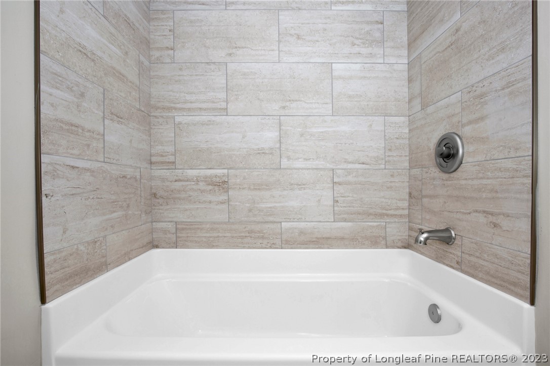 610 Arrowood Road Fayetteville, NC 28311 - Photo 17 of 26 a bathroom with a bathtub