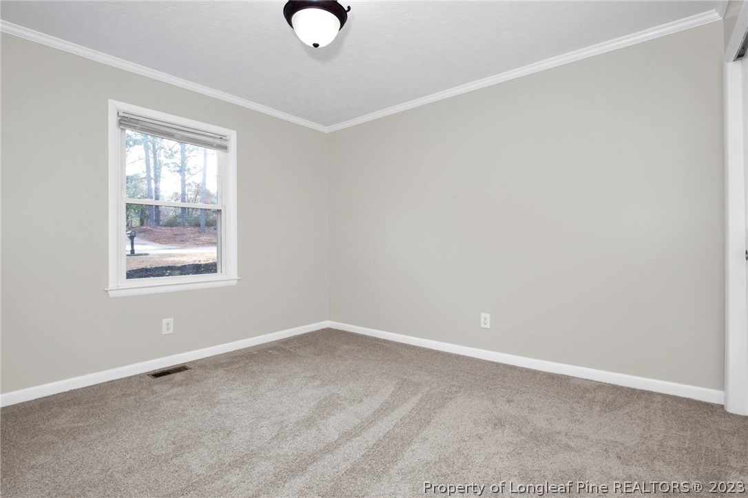 610 Arrowood Road Fayetteville, NC 28311 - Photo 18 of 26 an empty room with windows