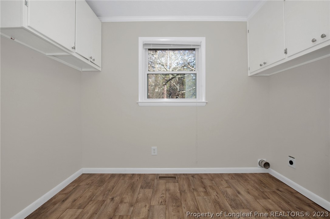 610 Arrowood Road Fayetteville, NC 28311 - Photo 24 of 26 a view of an empty room with wooden floor and a window