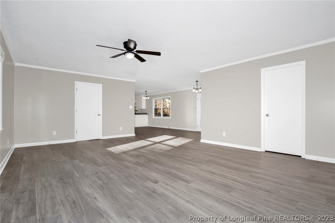 610 Arrowood Road Fayetteville, NC 28311 - Photo 10 of 26 an empty room with wooden floor and windows