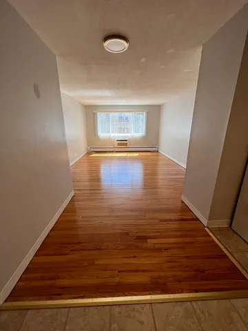 a view of room with wooden floor
