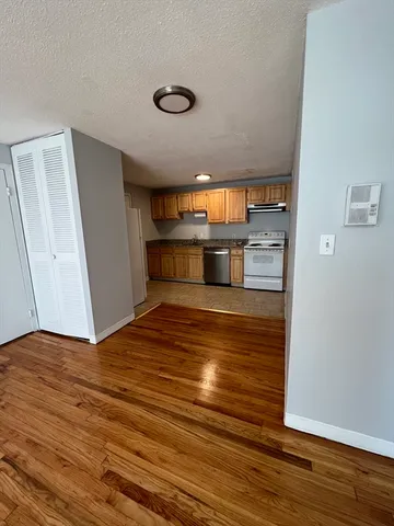 a view of a room with wooden floor and staircase