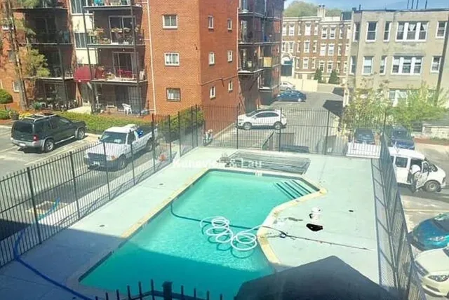 a view of a swimming pool with outdoor seating