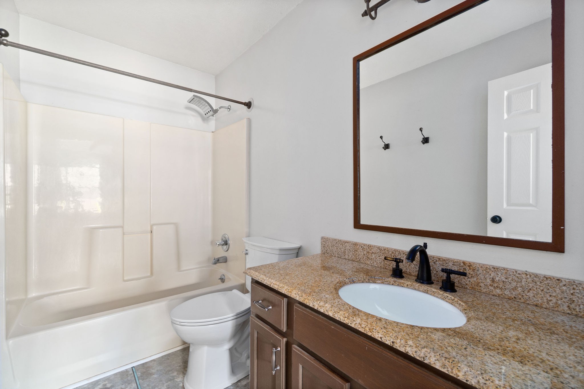 3328 Backridge Road Woodlawn, TN 37191 - Photo 17 of 28 a bathroom with a granite countertop sink toilet a mirror and shower