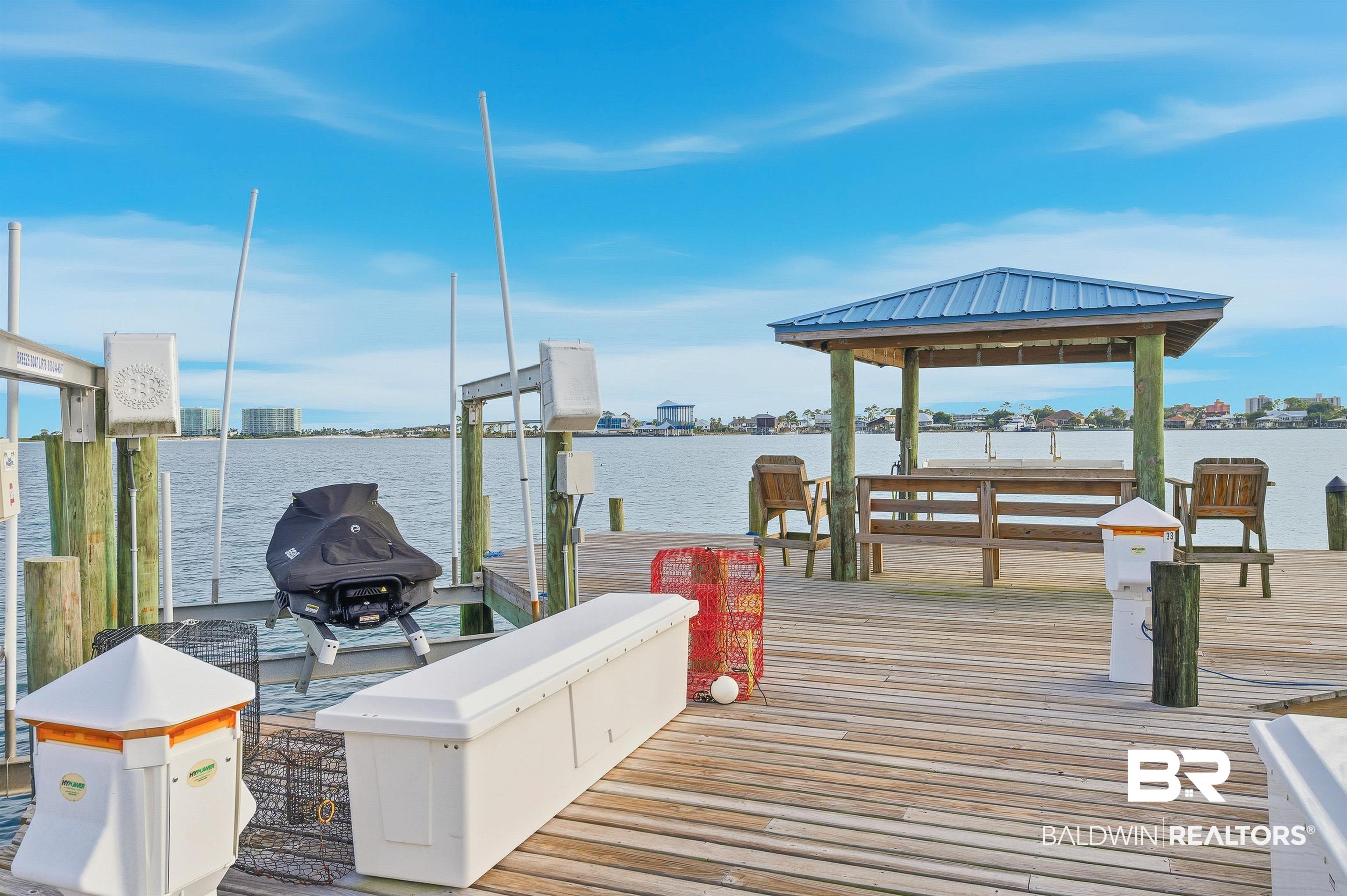 27282 Canal Road, Unit 408 Orange Beach, AL 36561 - Photo 24 of 37 Slip featuring boat lift, Water and power next to fish cleaning station