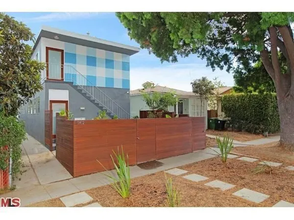 a view of a street with potted plants