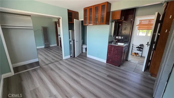 a view of kitchen and hallway with wooden floor