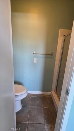 a bathroom with a granite countertop toilet and a sink