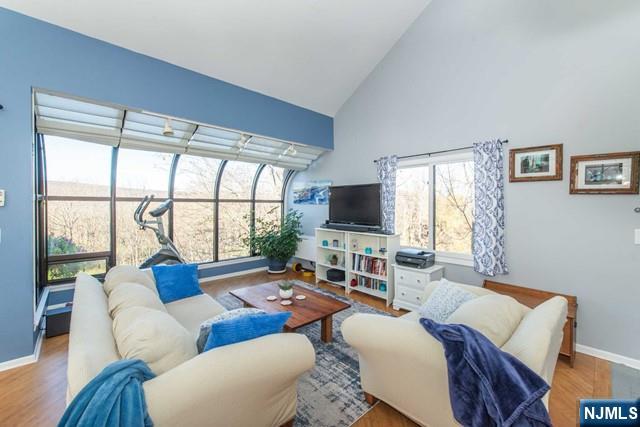 a living room with furniture a flat screen tv and a large window