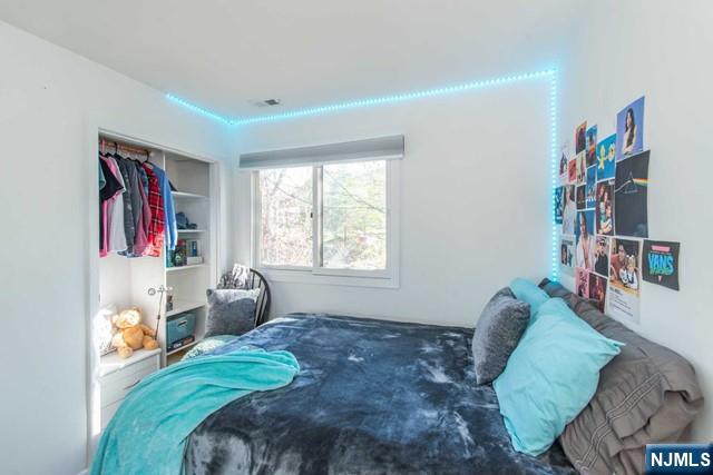 2 Falkenstein Drive, Unit 2 Vernon, NJ 07462 - Photo 16 of 24 a bed room with a bed and a chair